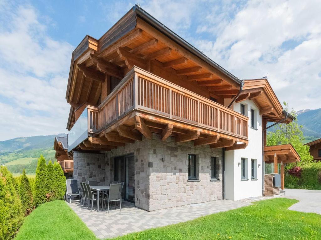 a house with a deck on top of a stone fireplace at Chalet in Niedernsill near Ski Slopes in Niedernsill