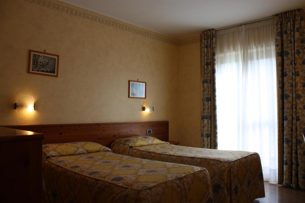 Postel nebo postele na pokoji v ubytování Hotel Beau Site