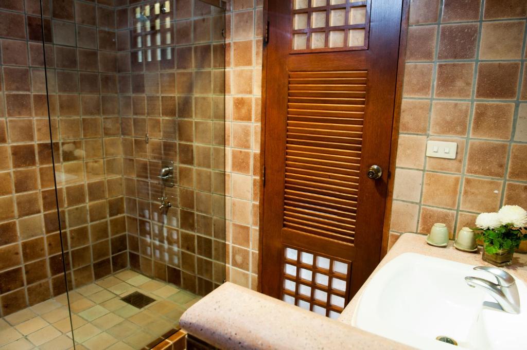a bathroom with a shower and a sink at Montien House - SHA Plus in Chaweng