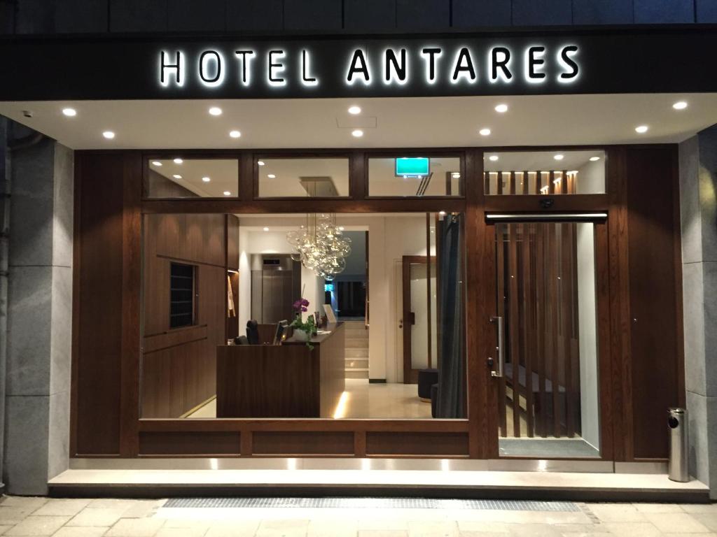 a hotel entrance with a sign that reads hotel antares at Hotel Antares in Munich