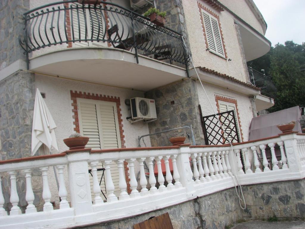 a balcony of a house with a white railing at Elios Residence Hotel in Sapri