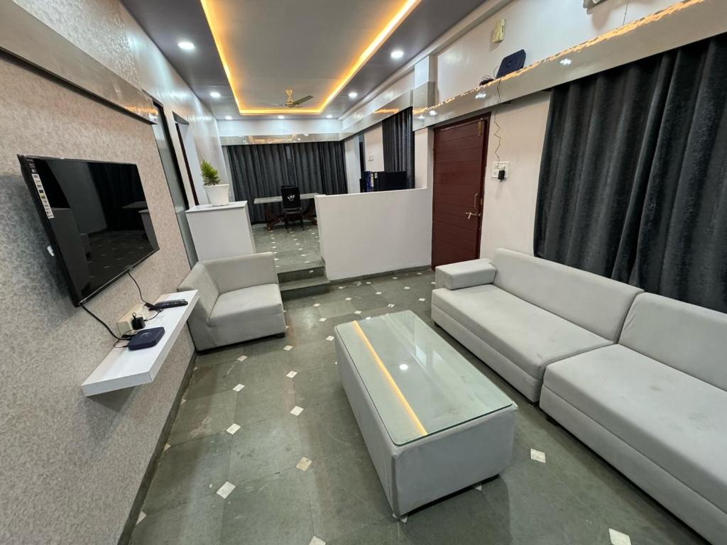 a living room with a couch and a tv at Satyabhama Homestay - Tulip - Two BHK luxury apartment in Indore