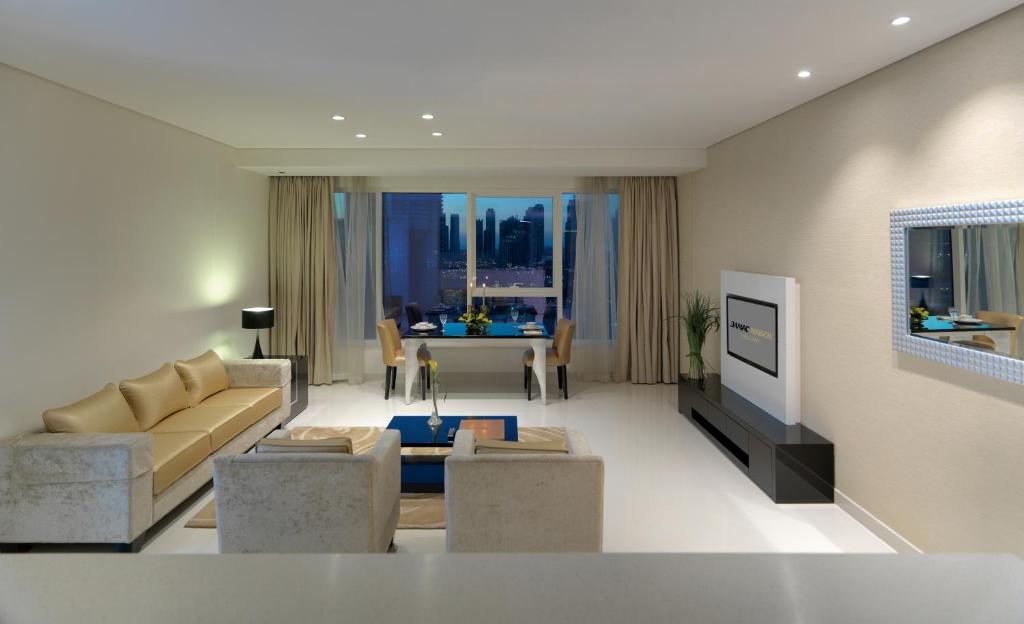 a living room with a couch and a table at DAMAC Maison Canal Views in Dubai