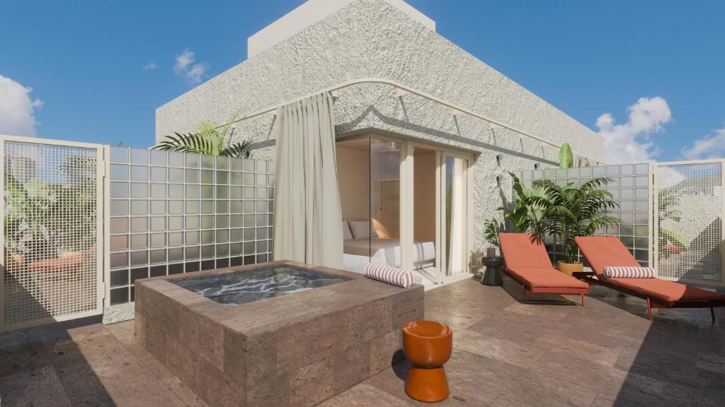 a patio with a hot tub and two chairs at Hotel Taro Santa Cruz in Santa Cruz de Tenerife