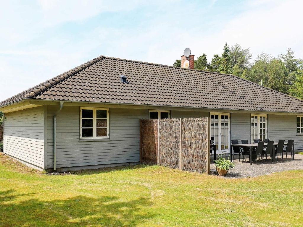 a small house with a table in the yard at 12 person holiday home in Hals in Hals