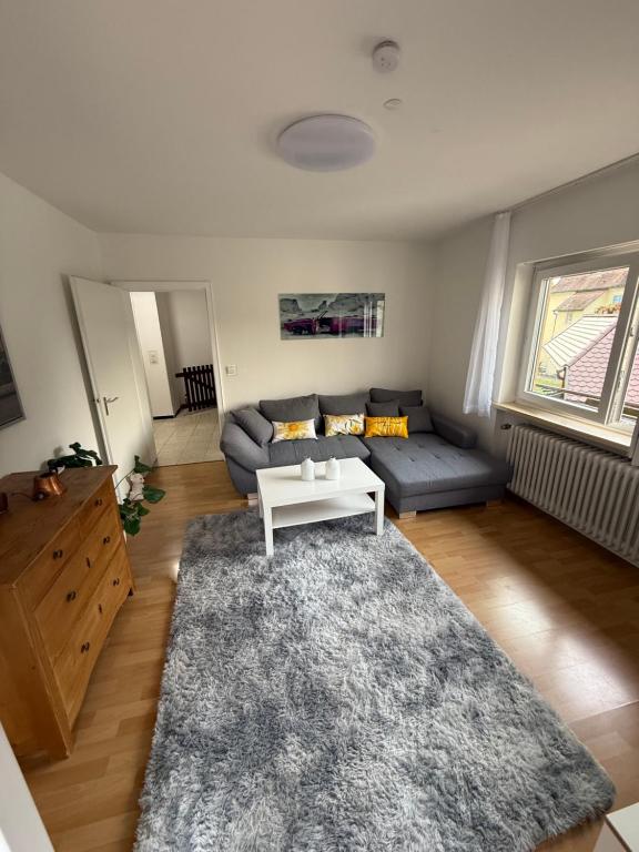 a living room with a couch and a table at Ferienwohnung Mönchshof in Emmendingen