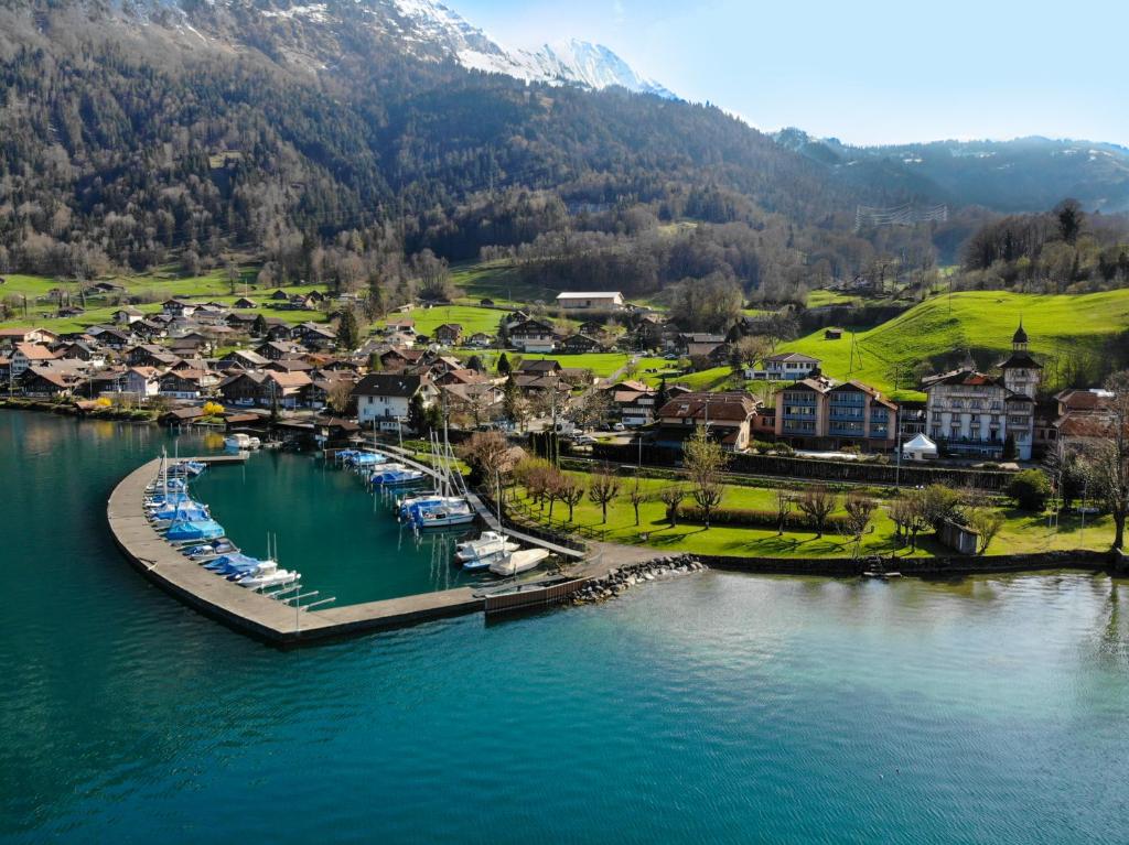 une vue aérienne d'une petite ville au bord d'un lac dans l'établissement Hotel Du Lac - Self Check-in, à Därligen