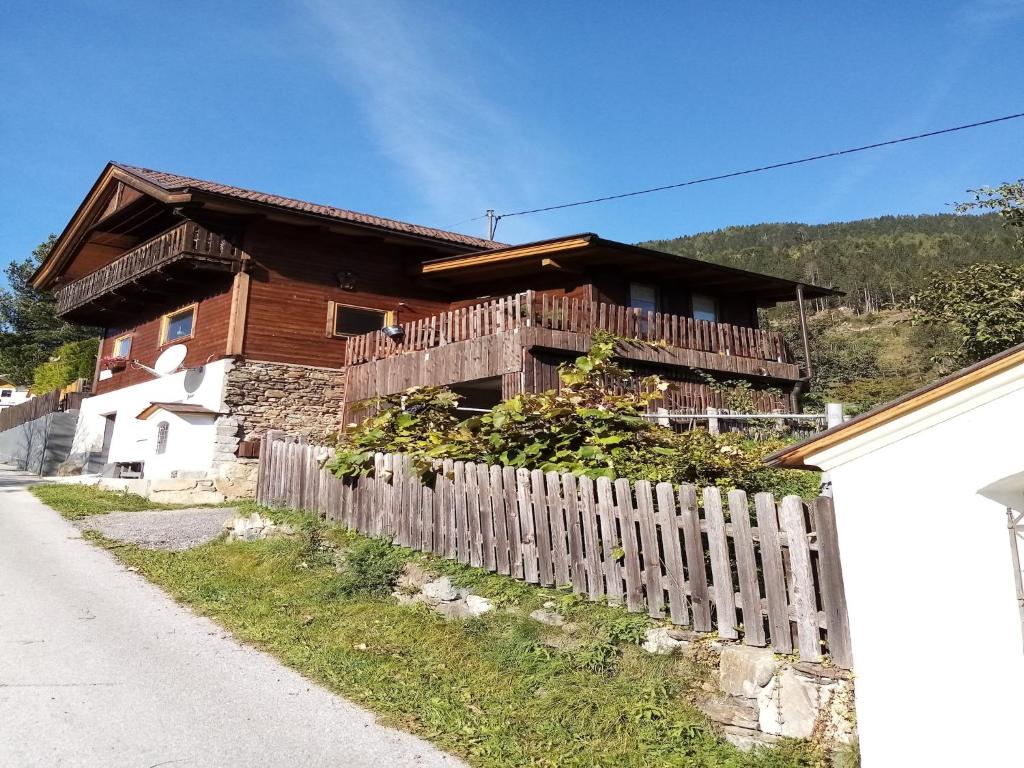 a wooden house with a fence in front of it at Chalet in Rangersdorf near Ski Slopes in Rangersdorf