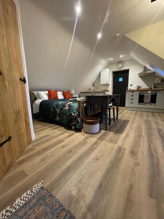 a bedroom with a bed and a table in a room at Roseberry View Barn, Northallerton in Northallerton