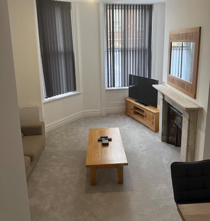 a living room with a tv and a coffee table at 3 Russell street, Flat 2 in Gloucestershire