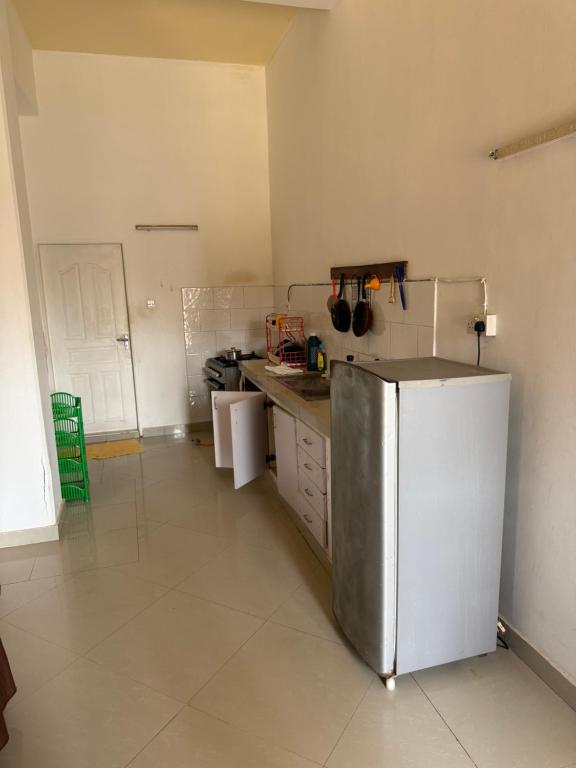 a kitchen with a stainless steel refrigerator in it at Samira House in Mombasa