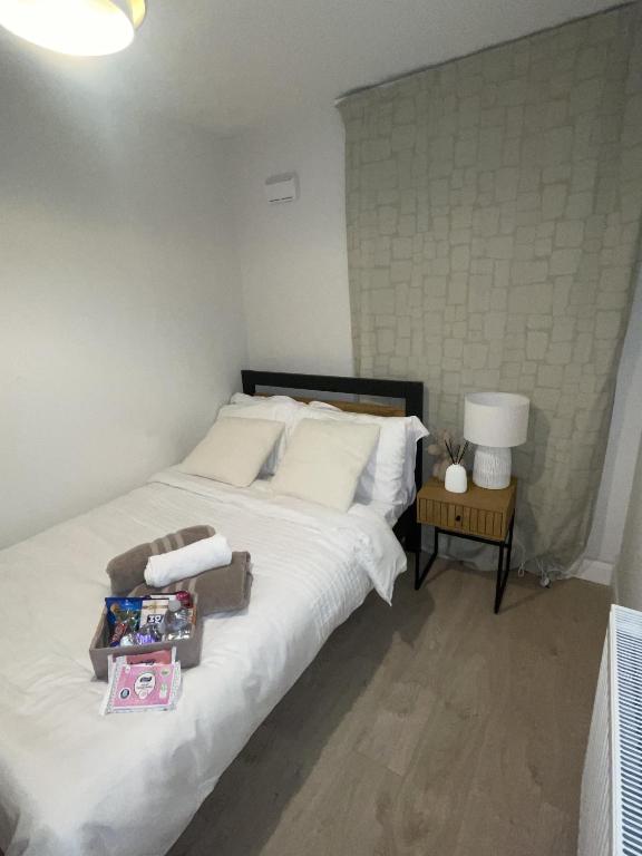 a bedroom with a large white bed and a table at The Sheltuh in Dublin