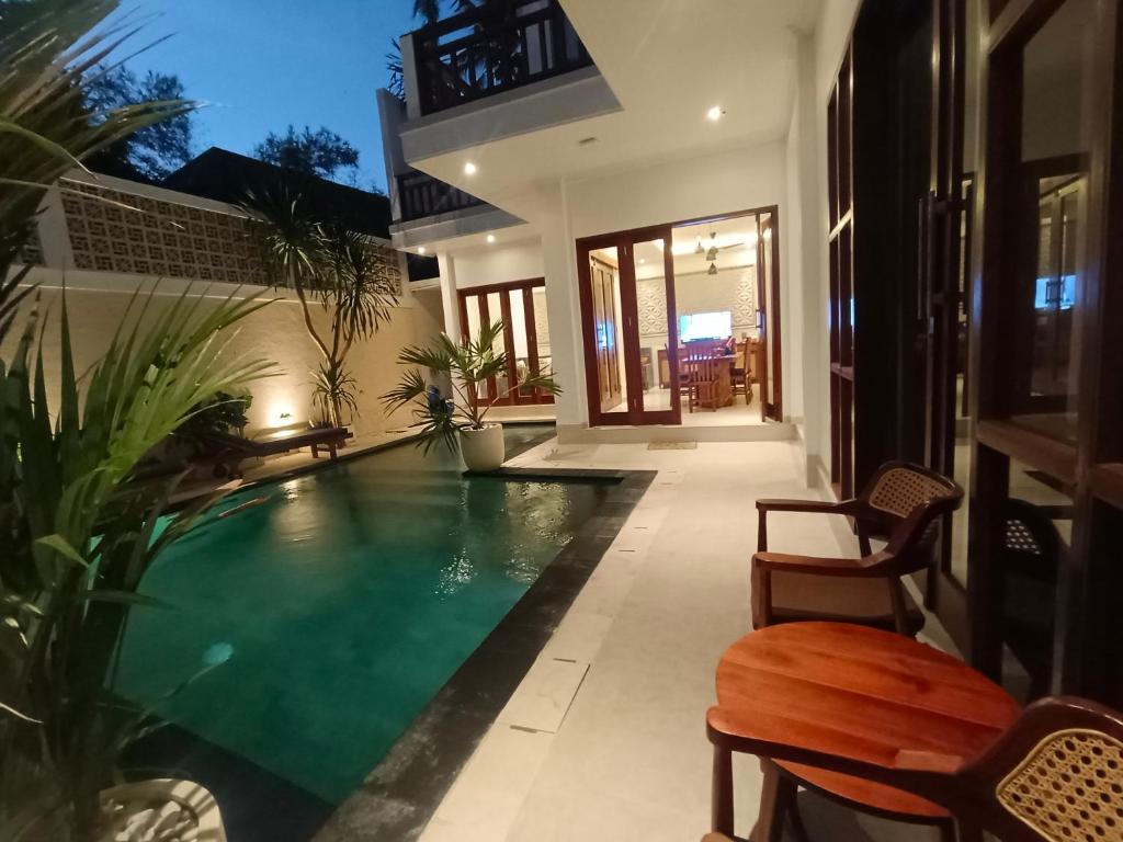 a swimming pool in the middle of a house at Artha Sadia Villa 2 Seseh Beach in Cemagi