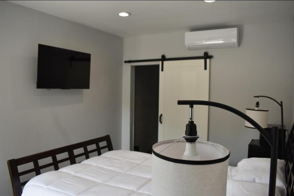 a bedroom with a bed with a lamp on it at Tanersville Village Rooms on Saw Mill Creek in Tannersville