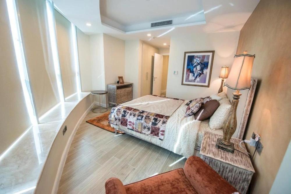 a bedroom with a bed and a large window at Paramount Stay in Islamabad