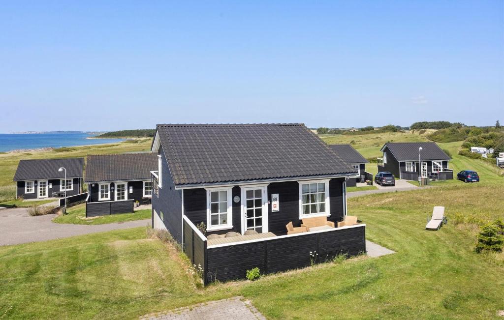 an overhead view of a black house on a grass field at Holiday Home Strandgårdsvej Bagenkop Denm in Bagenkop