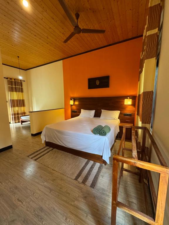 a bedroom with a bed and a wooden ceiling at Green turtle in Tangalle