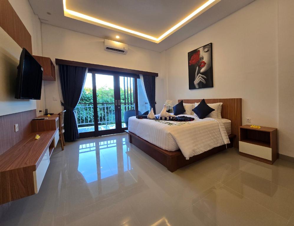 a bedroom with a bed and a television in it at The Polle Canggu in Badung