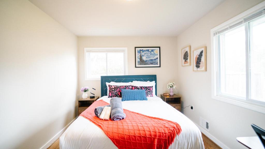a bedroom with a large bed with a red blanket at Gorgeous 7BR 3BA Family Home in Maryland in Oxon Hill