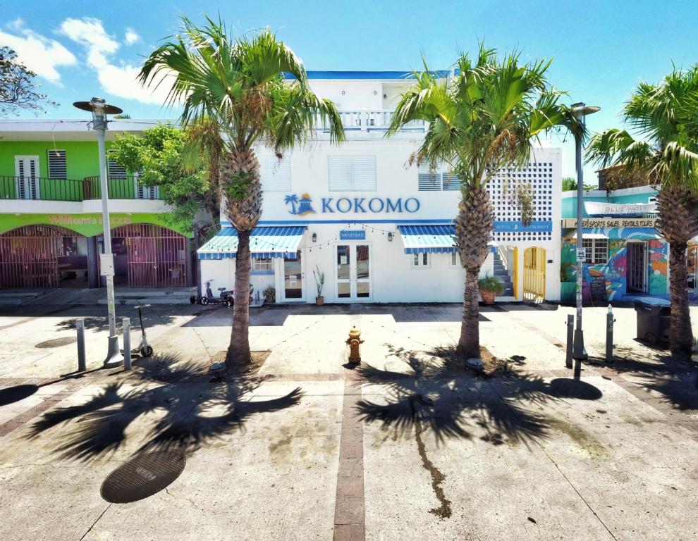a group of palm trees in front of a building at Kokomo Hotel in Culebra