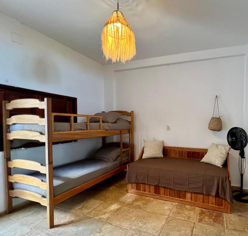 a bedroom with two bunk beds and a chandelier at Casa Ametista in Jericoacoara