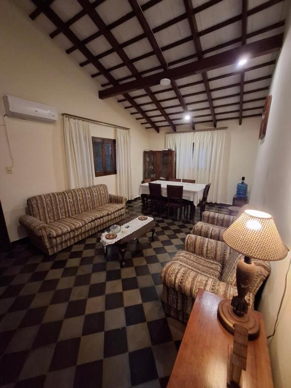 a living room with couches and a checkerboard floor at Casa Encarnación in Encarnación