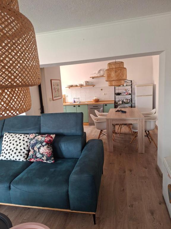 a living room with a blue couch and a table at San Marco Makarska in Makarska