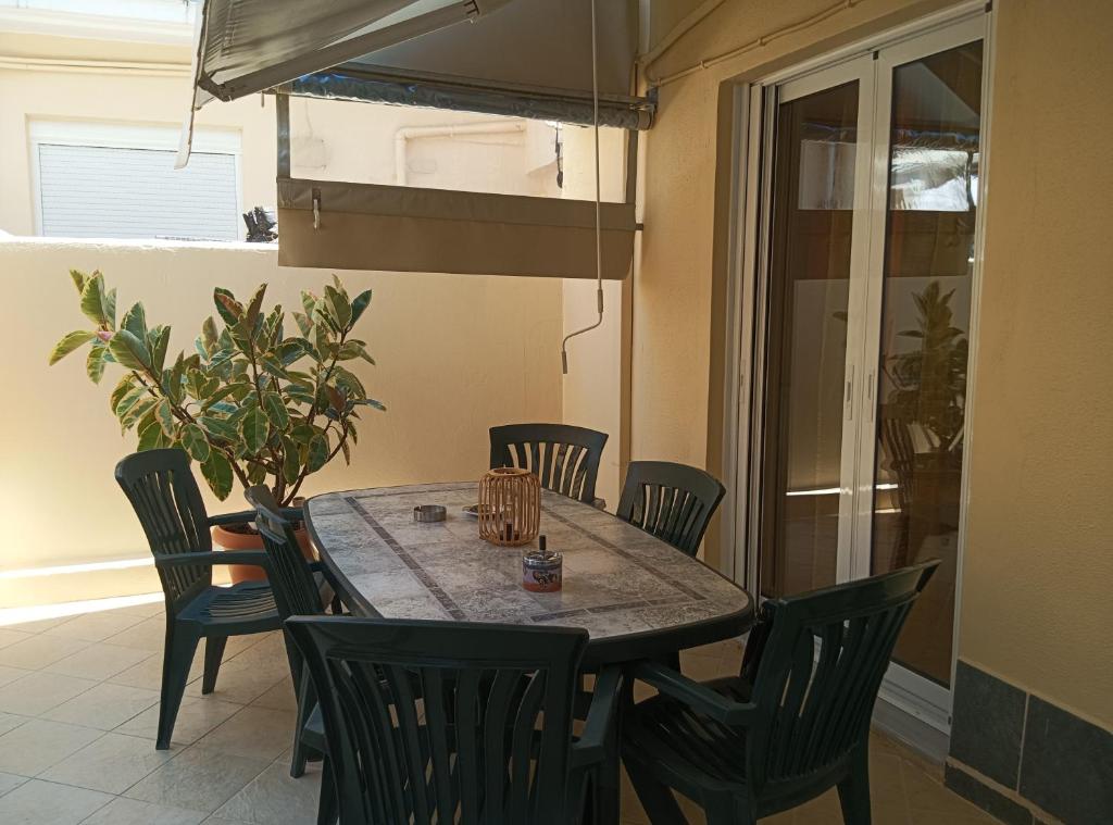 a dining room with a table and chairs at Olga's House in Preveza