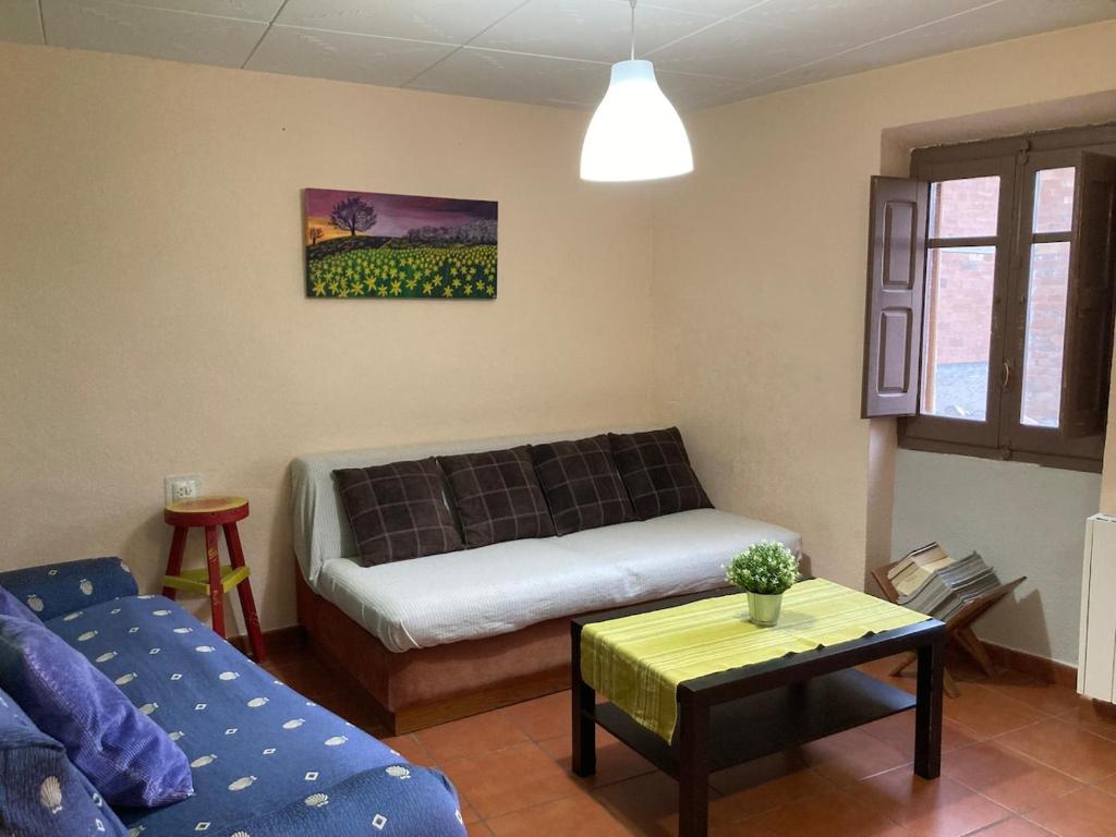 a living room with a couch and a table at Casa para escaladores o relax, in Bisbal de Falset