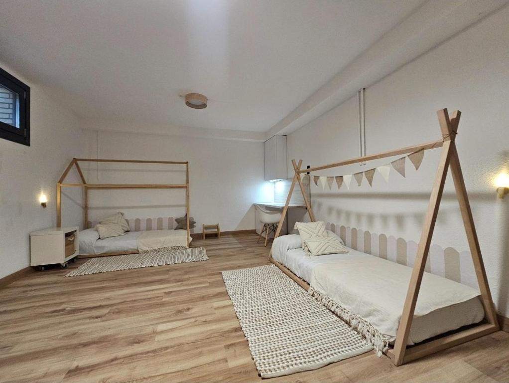 a large room with two beds and a desk at Chez Marie in La Muela