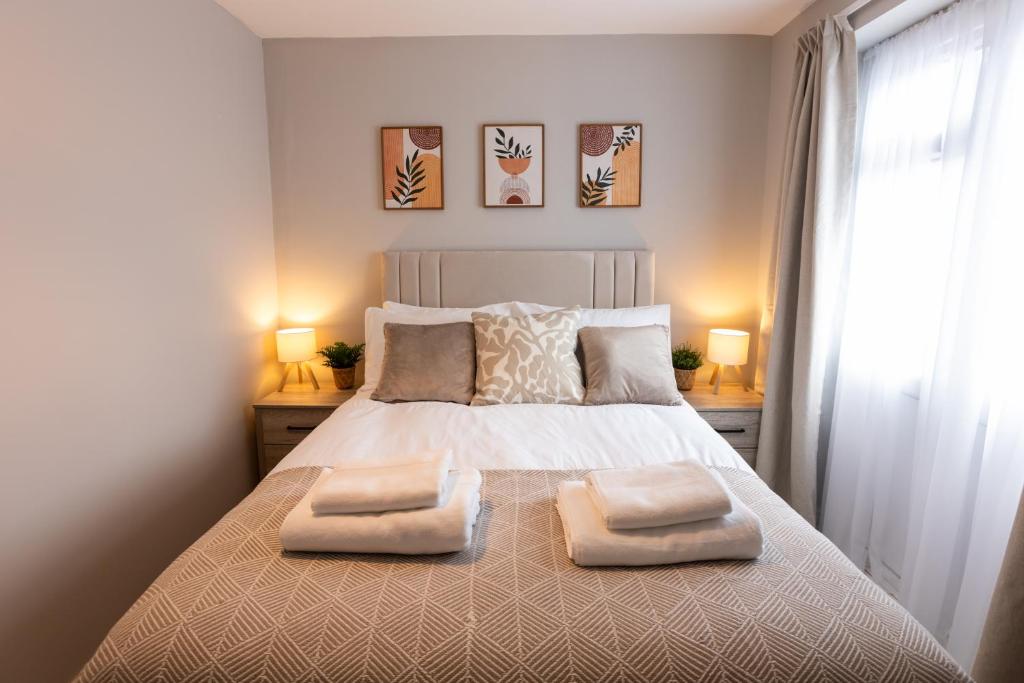 a bedroom with a bed with two pillows on it at Birmingham Central Cosy 4BR Home with Free Parking in Birmingham