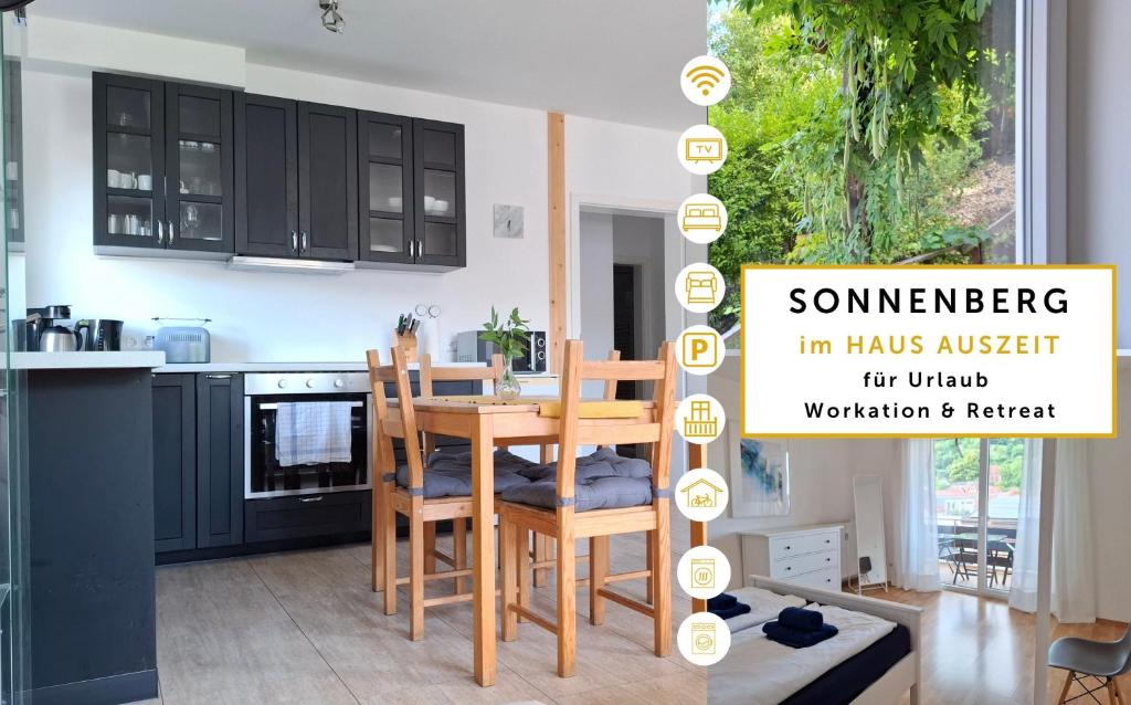 a kitchen with black cabinets and a table and chairs at Sonnenberg im Haus Auszeit 2 BR Fahrradgarage Parken in Leinsweiler