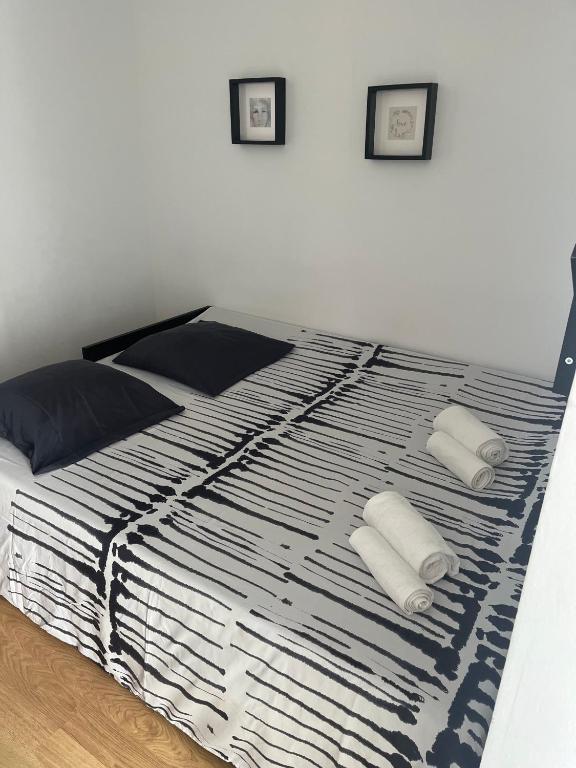 a bedroom with a bed with two pillows on it at Duplex no estoril in Estoril
