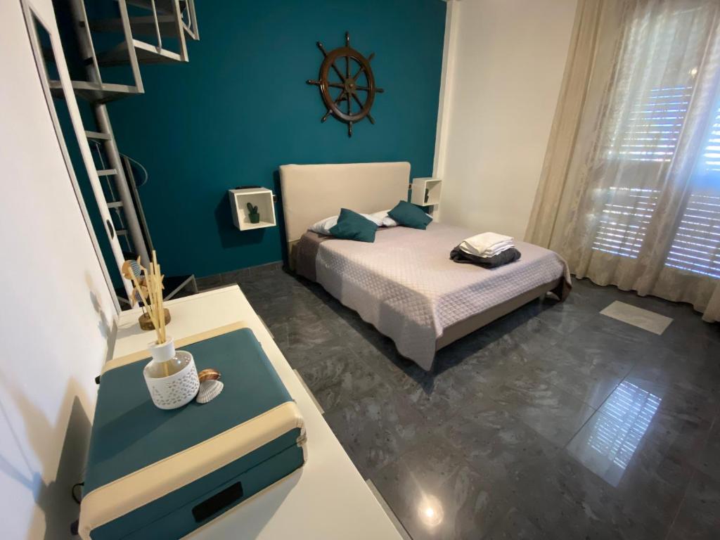 a small bedroom with a bed and a ladder at La dimora del marinero in San Benedetto del Tronto