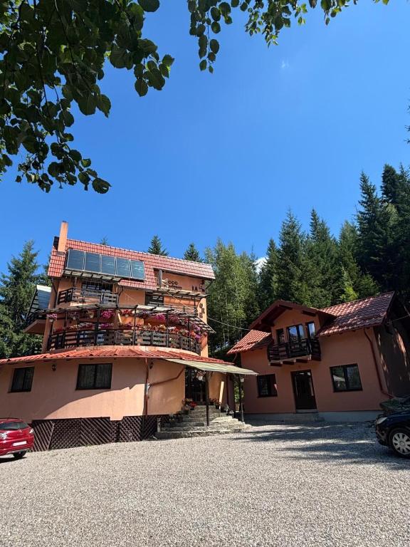 a large building with a balcony on the side of it at Perla Sarisorului in Sărişor