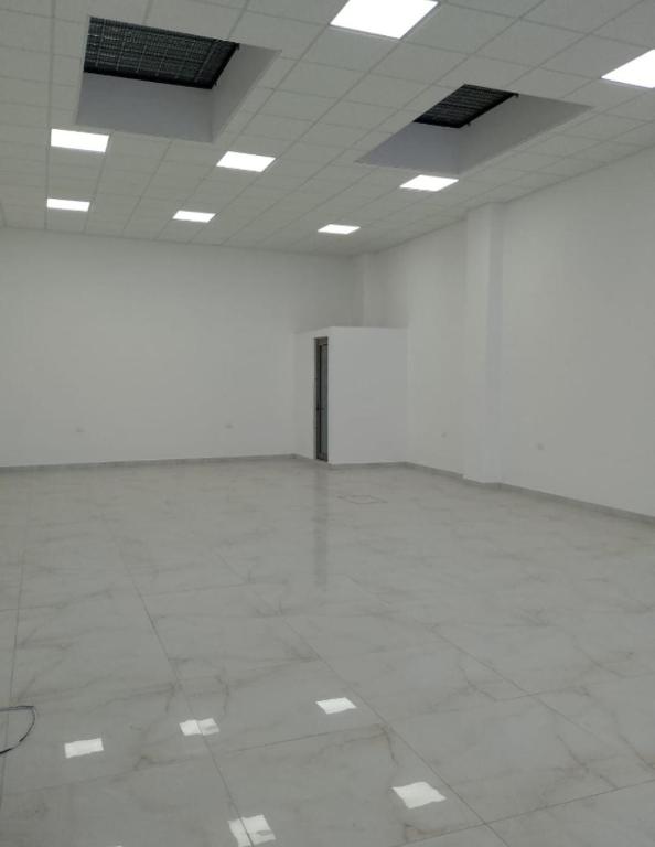 a large empty room with white floors and lights at Edificio Confort in San Felipe Hueyotlipan