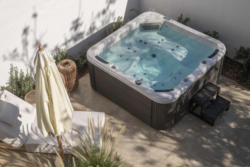 a large jacuzzi tub sitting on a patio at Saitis Luxury Residence - 15 min from Matala - Kommos - Kalamaki Beach in Tympáki