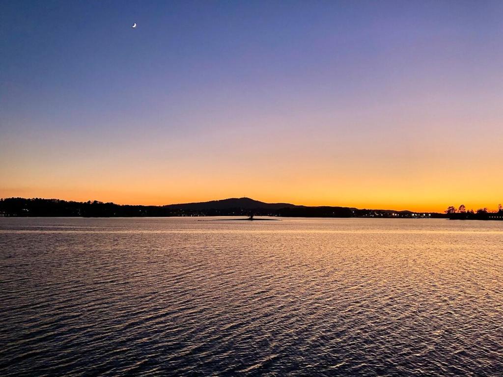 a sunset over a large body of water at Yoga Castia Complimentary Canoeing in Hot Springs