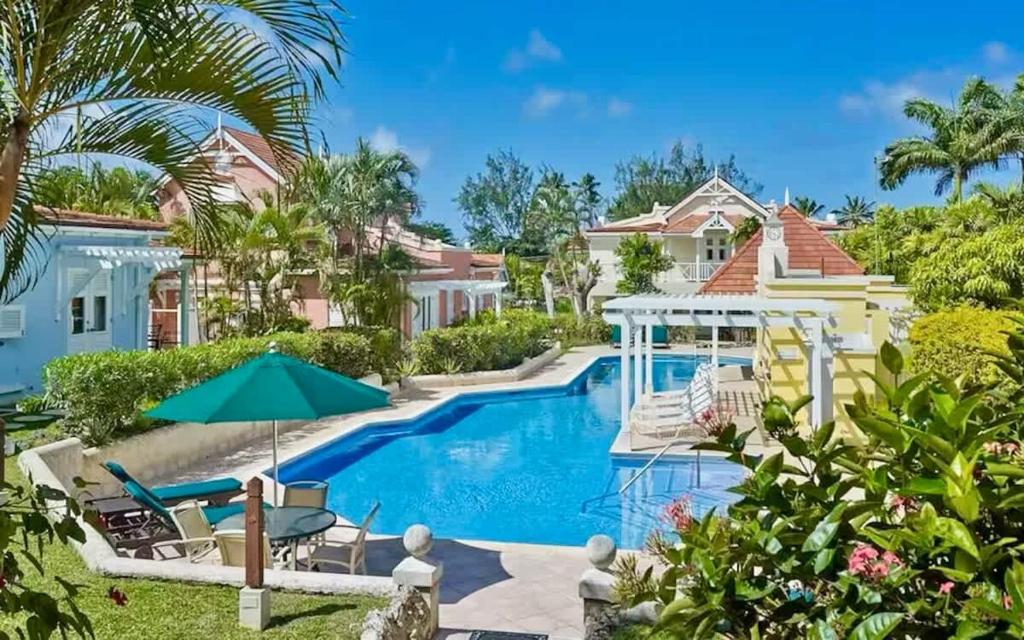 a villa with a swimming pool and a house at ZenBreak Kings Beach #12 in Saint Peter