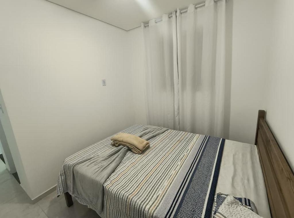 a bedroom with a bed with a towel on it at Recanto da Totô in Paraty