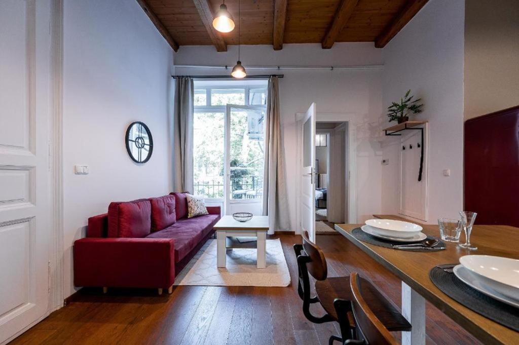a living room with a red couch and a table at Amsterdam Vintage Industrial Style in Košice