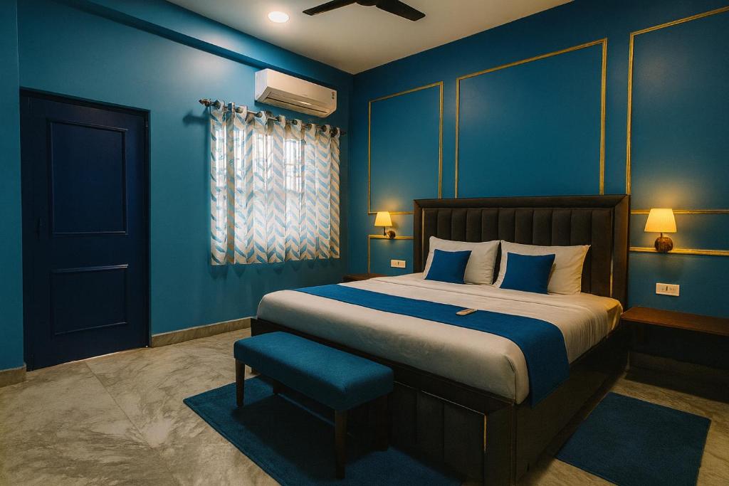 a blue bedroom with a bed and a blue wall at Kashivas - 2BHK near Assi Ghat in Varanasi