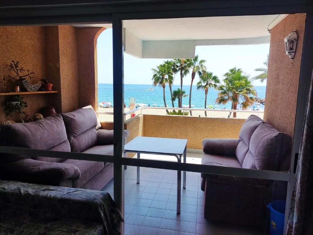 a living room with a view of the ocean at Garage Gratis y en la Playa in Almería