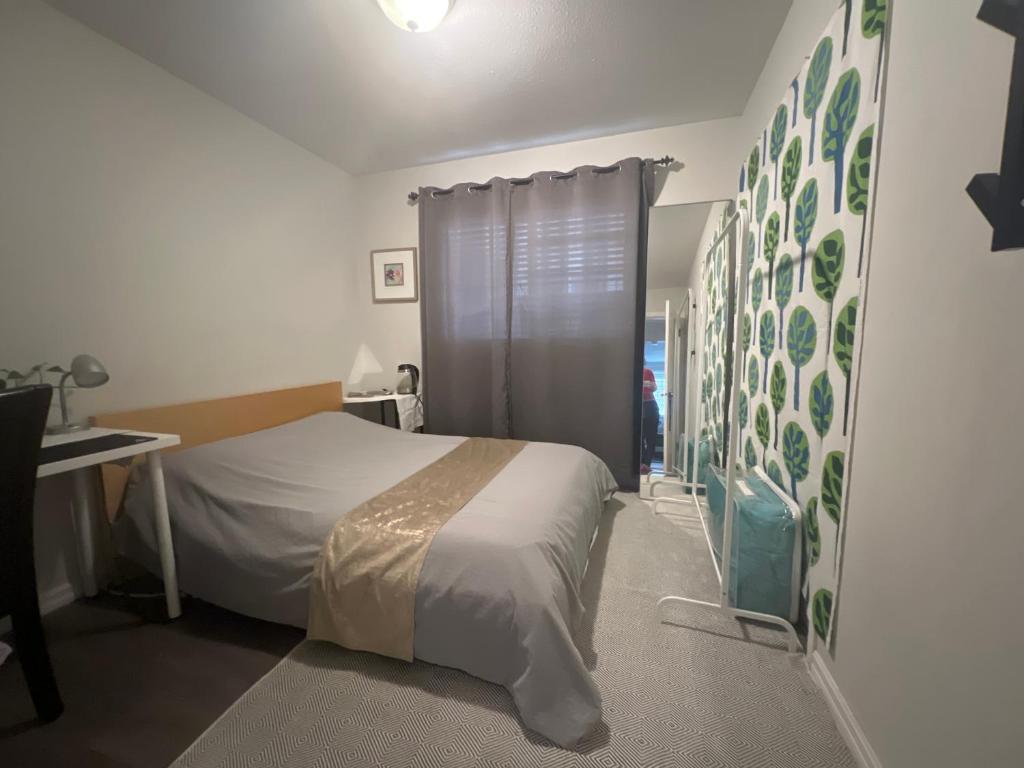 a bedroom with a bed and a desk and a window at Vancouver airport 7mins away joy room in Richmond