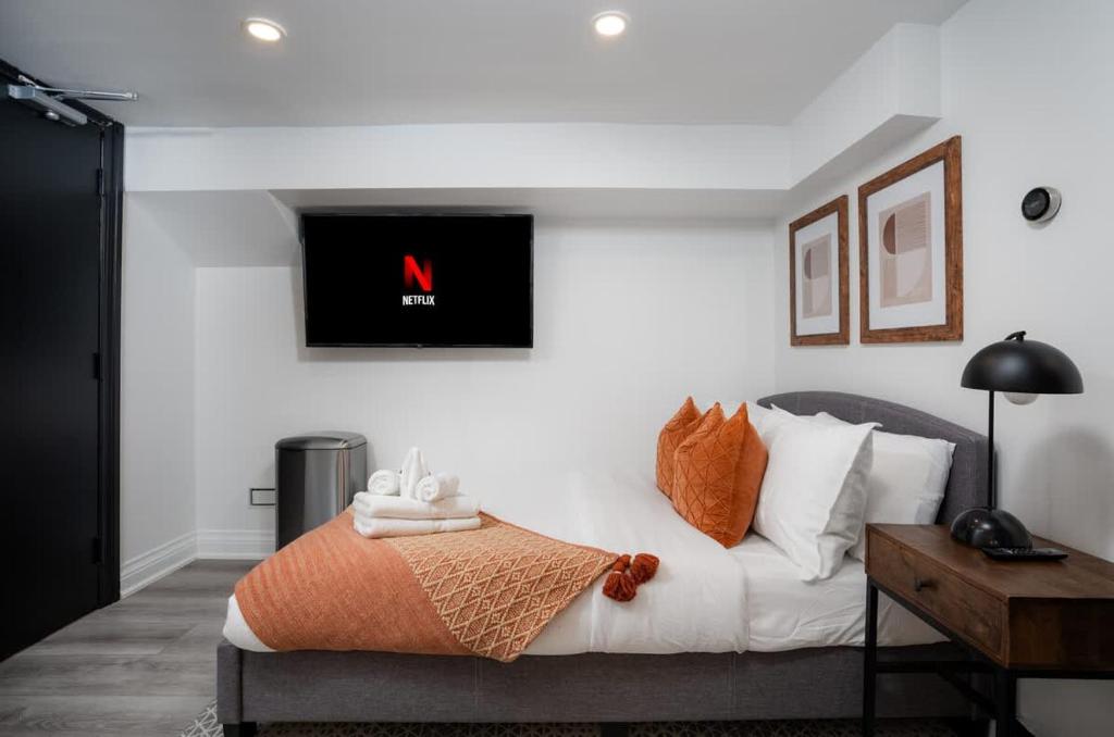 a bedroom with a bed with a television on the wall at Luxury Studio Condo in Downtown Toronto Elm Street in Toronto