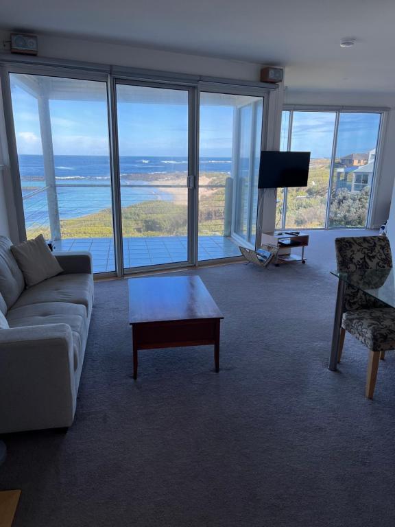 a living room with a couch and a table at Wytonia Penthouse in Port Fairy