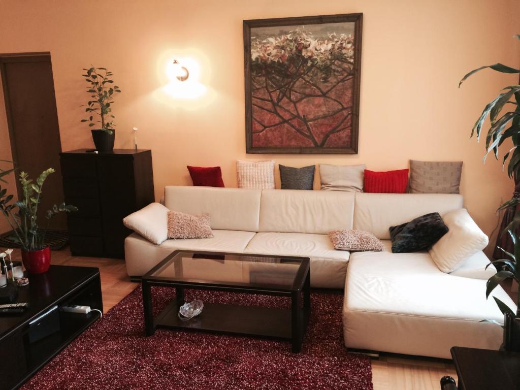 a living room with a white couch and a table at Luxury Dana's City Centre Apartment in Kaunas