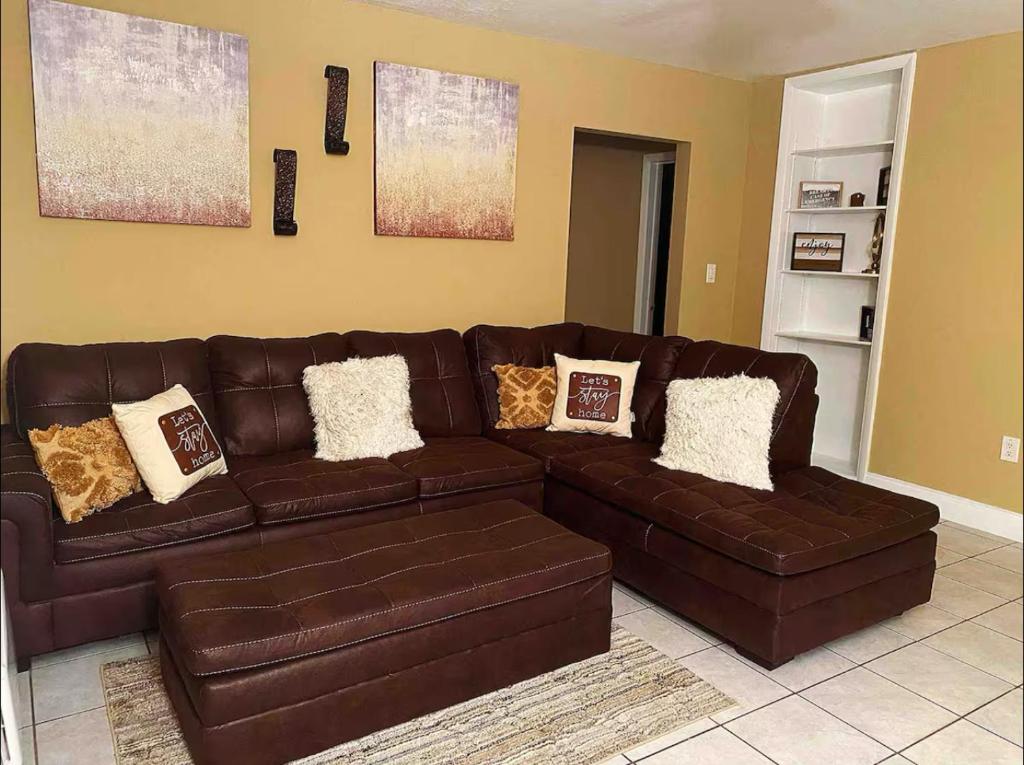 a brown leather couch in a living room at Lovely 2 Bedroom Condo With Free Parking & Wifi!! in Sunrise