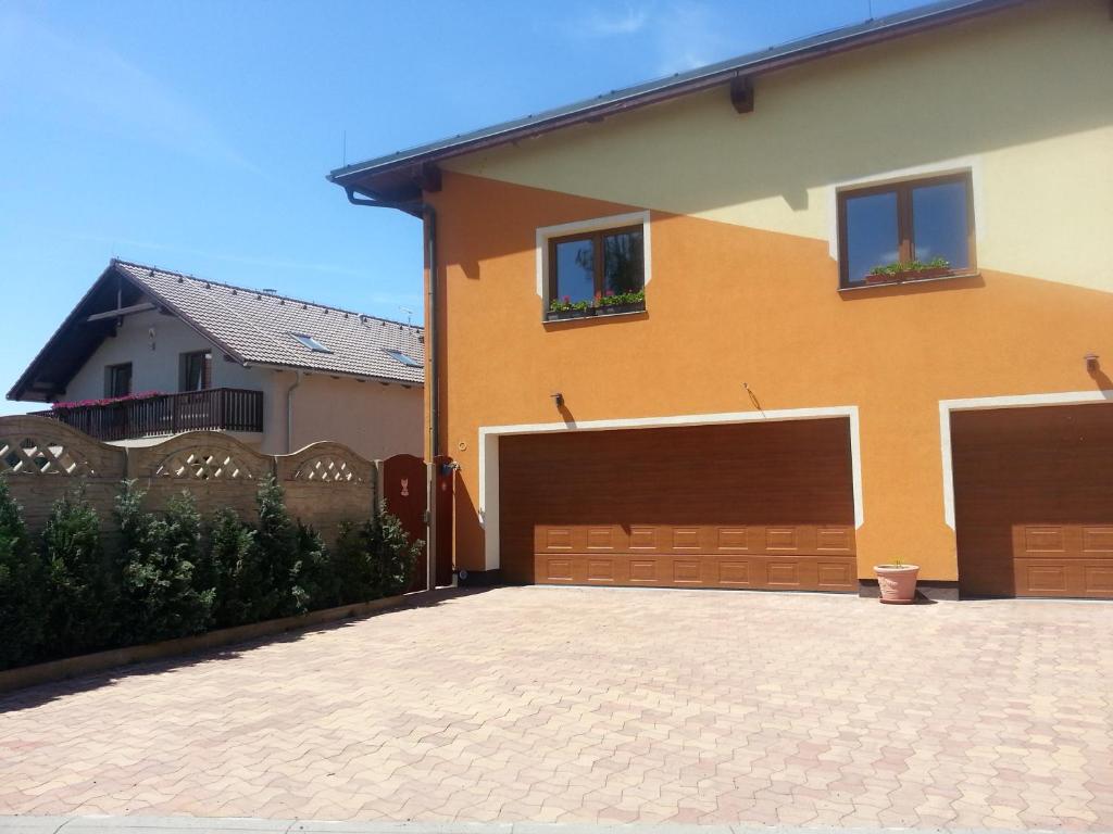 a house with a brick driveway in front of it at Pension Sunset Mezirolí in Nová Role
