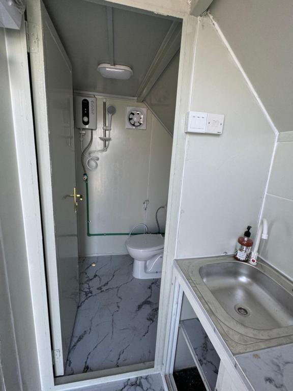 a bathroom with a sink and a toilet at كرفان السرور على البحر in Half Moon Bay